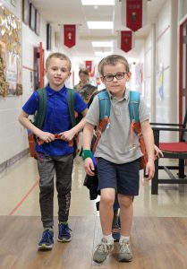 Boys walking in school hallway